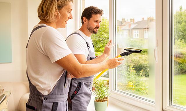 Customer and window cleaner checking the finished glass from inside a bright Newcastle home